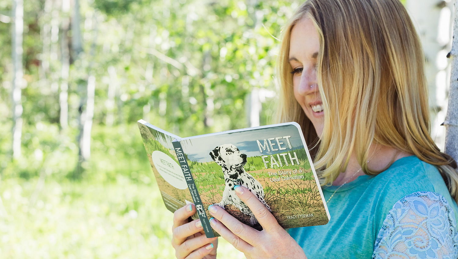 Author Tracy Tydeman Holding Her Book Meet Faith - The Story of a Deaf Dalmatian